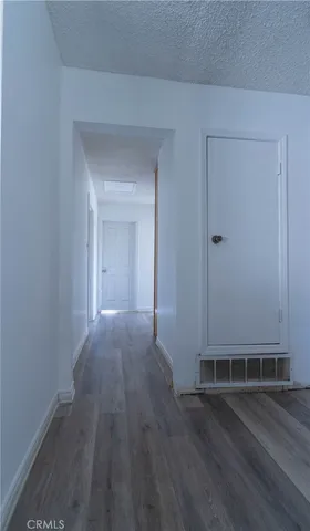 a view of a livingroom with wooden floor and a window
