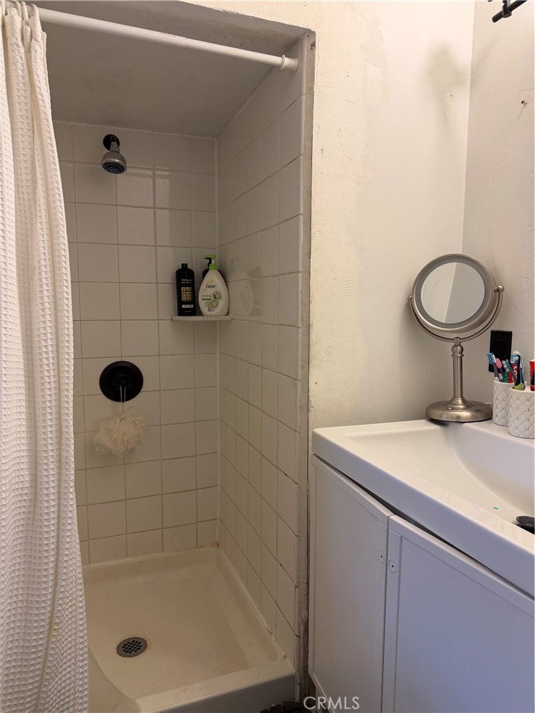 13116 Weidner Street Pacoima, CA 91331 - Photo 12 of 21 a bathroom with a shower toilet and sink