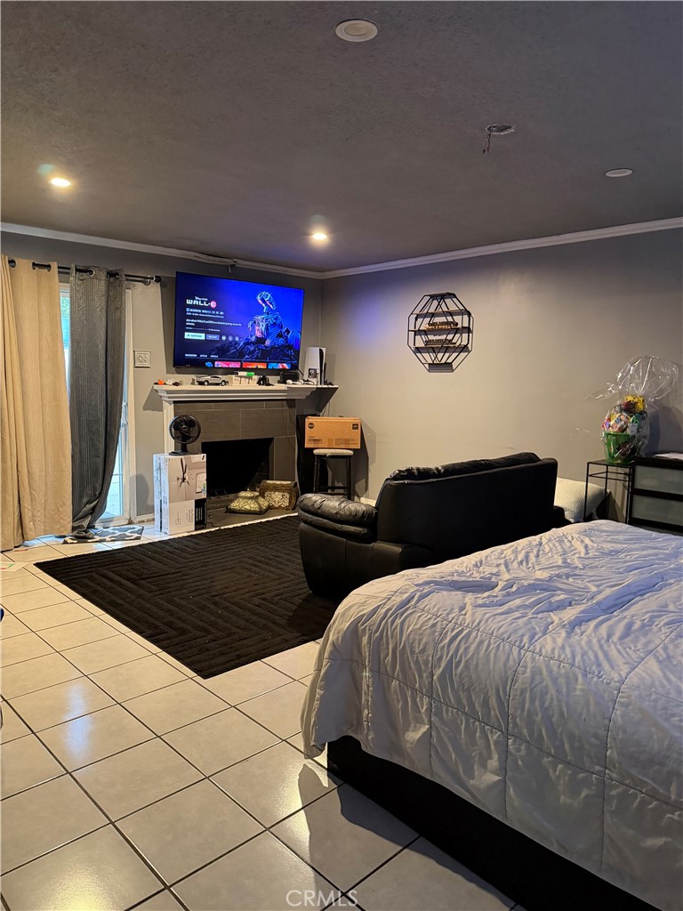 13116 Weidner Street Pacoima, CA 91331 - Photo 13 of 21 a bed room with a bed and a television
