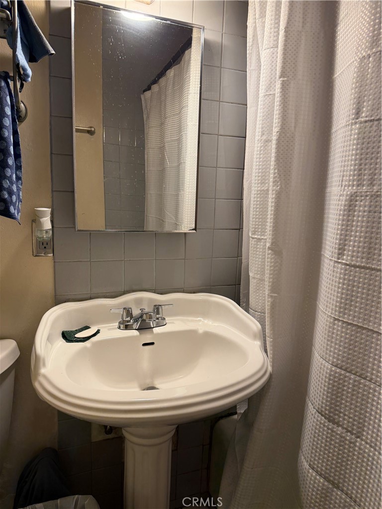 13116 Weidner Street Pacoima, CA 91331 - Photo 7 of 21 a sink sitting in a bathroom next to a sink