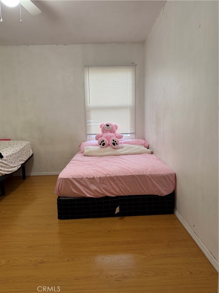 13116 Weidner Street Pacoima, CA 91331 - Photo 8 of 21 a bedroom with a bed and window
