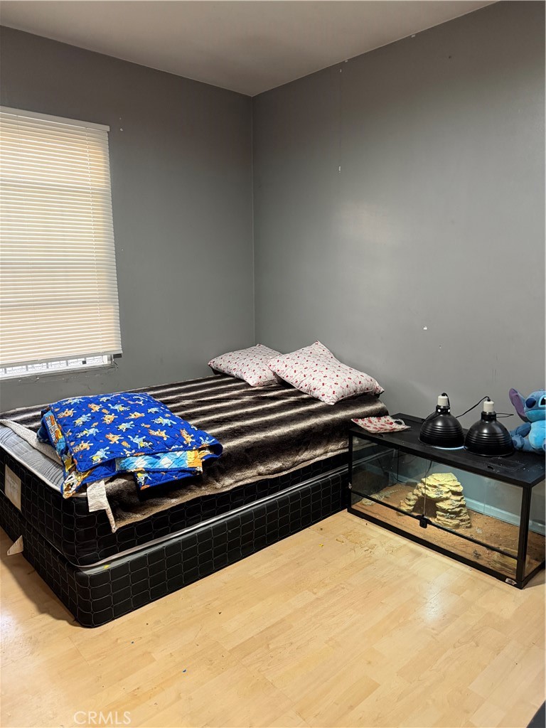 13116 Weidner Street Pacoima, CA 91331 - Photo 10 of 21 a bed sitting in a room next to a window