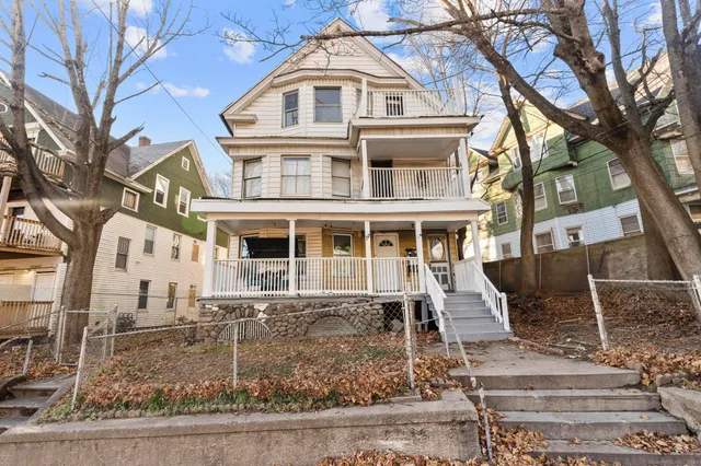 a front view of a residential apartment building with a yard