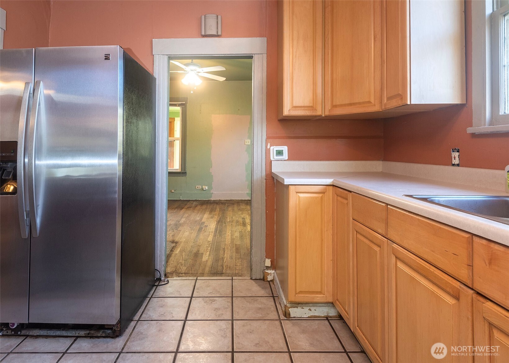 2214 North 60th Street Seattle, WA 98103 - Photo 9 of 22 a kitchen with a refrigerator and cabinets