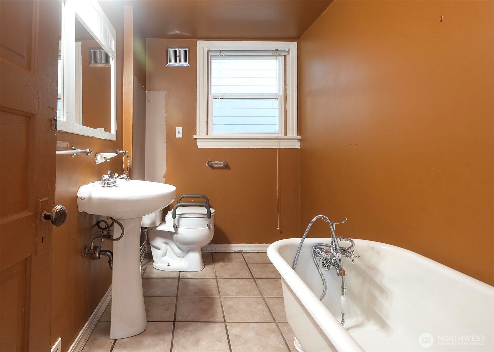 2214 North 60th Street Seattle, WA 98103 - Photo 10 of 22 a bathroom with a sink a toilet and mirror