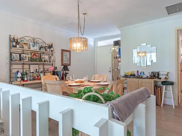 a dining room with furniture and a chandelier