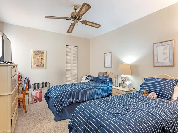 a bedroom with bed and a chandelier
