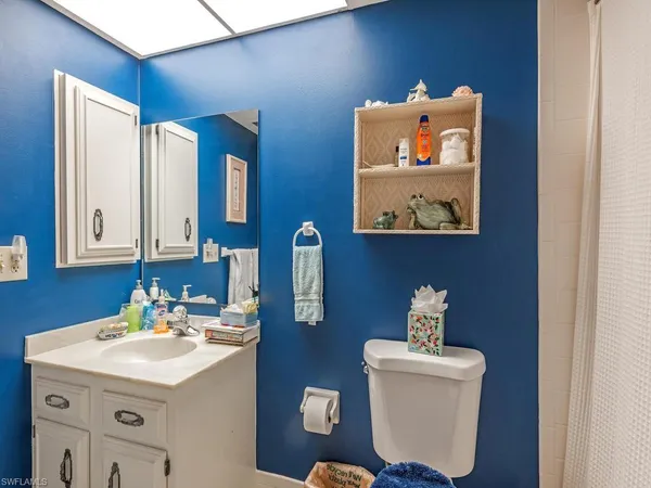 a bathroom with a sink and mirror with toilet
