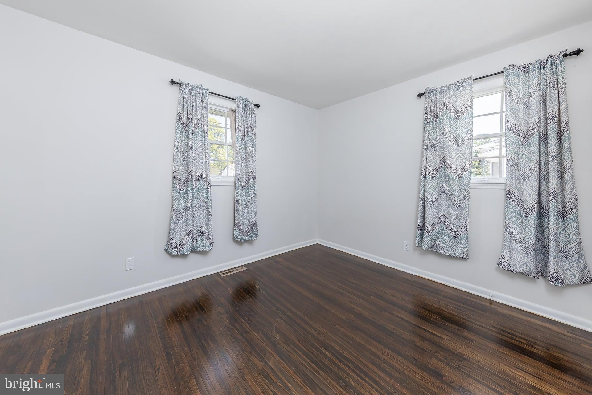 1203 Cedar Drive Pine Hill, NJ 08021 - Photo 11 of 19 an empty room with wooden floor and windows