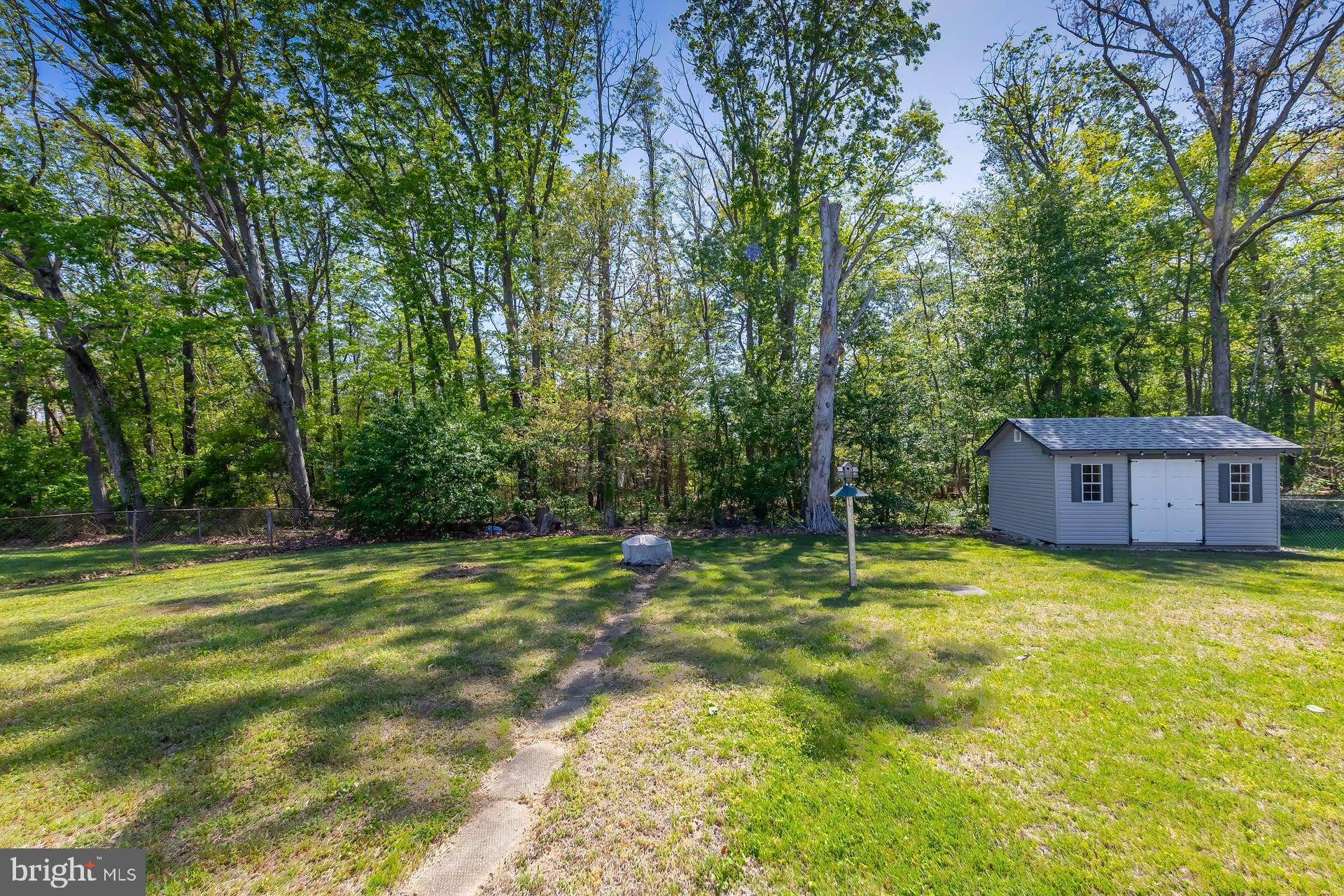1203 Cedar Drive Pine Hill, NJ 08021 - Photo 16 of 19 a swimming pool with some trees in the background