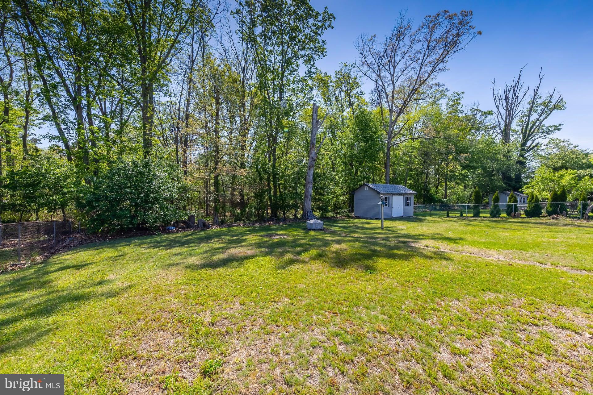 1203 Cedar Drive Pine Hill, NJ 08021 - Photo 17 of 19 a swimming pool with yard and trees in the background