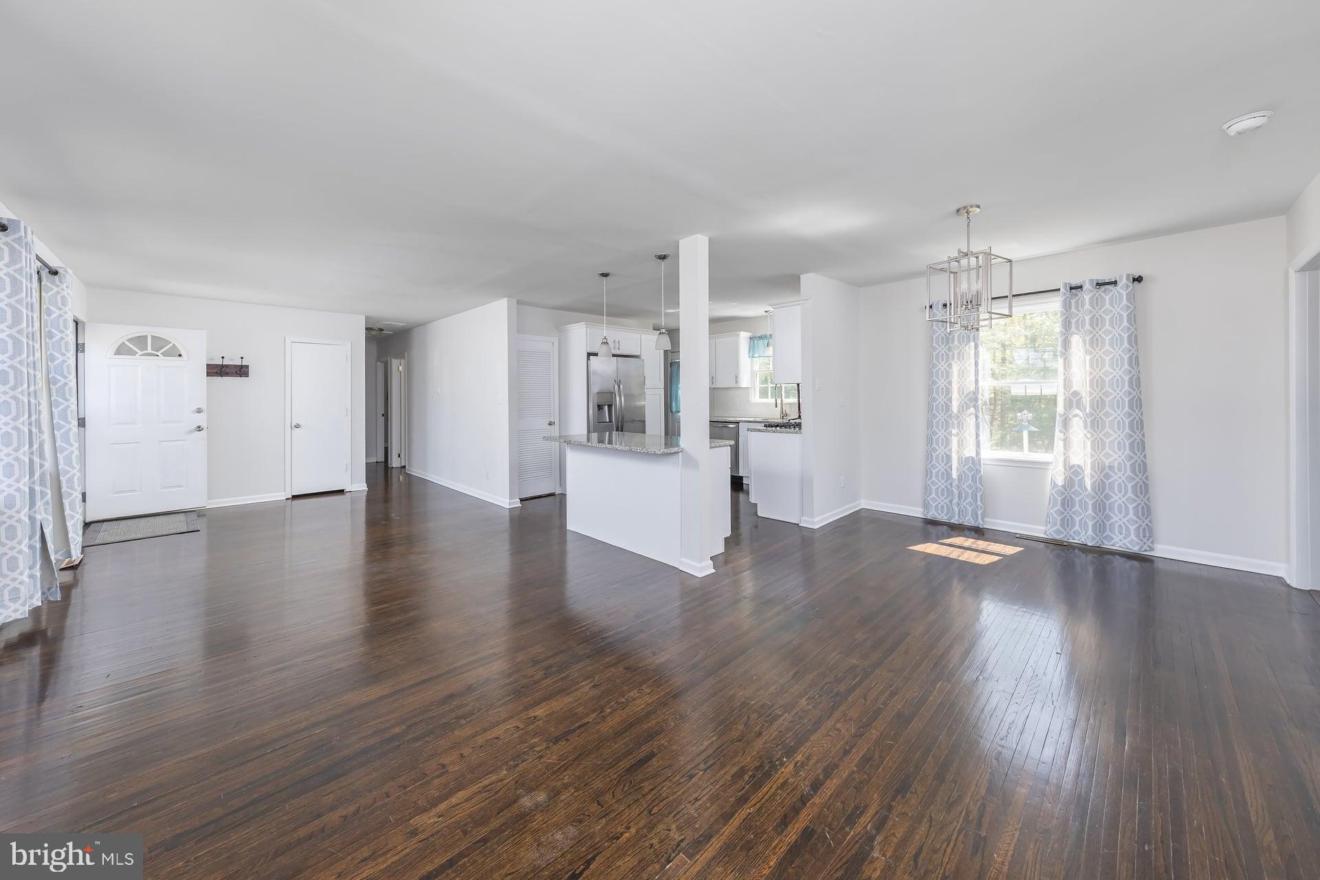 1203 Cedar Drive Pine Hill, NJ 08021 - Photo 2 of 19 a view of a kitchen with wooden floor and a window