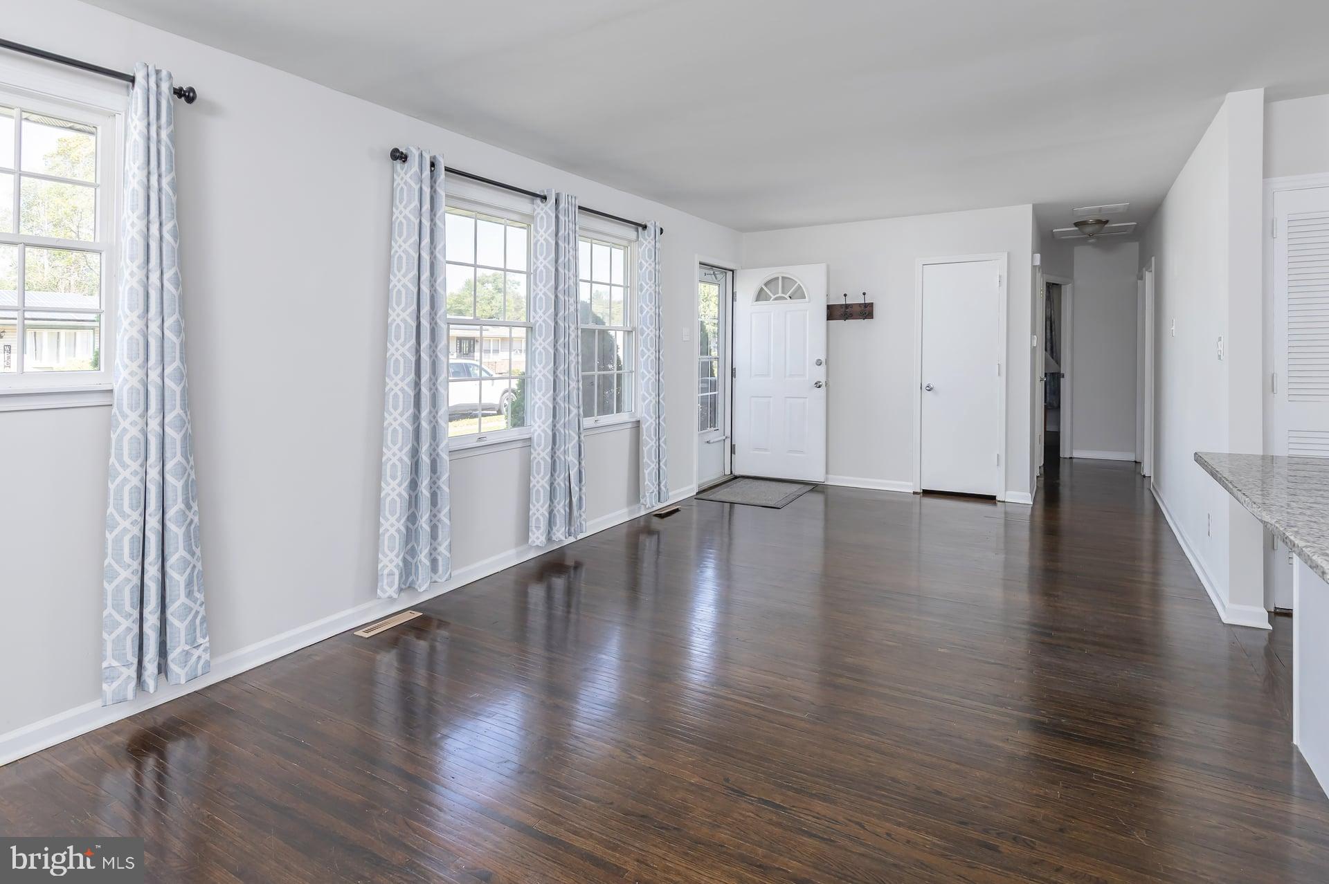 1203 Cedar Drive Pine Hill, NJ 08021 - Photo 4 of 19 a view of an empty room with wooden floor and a window