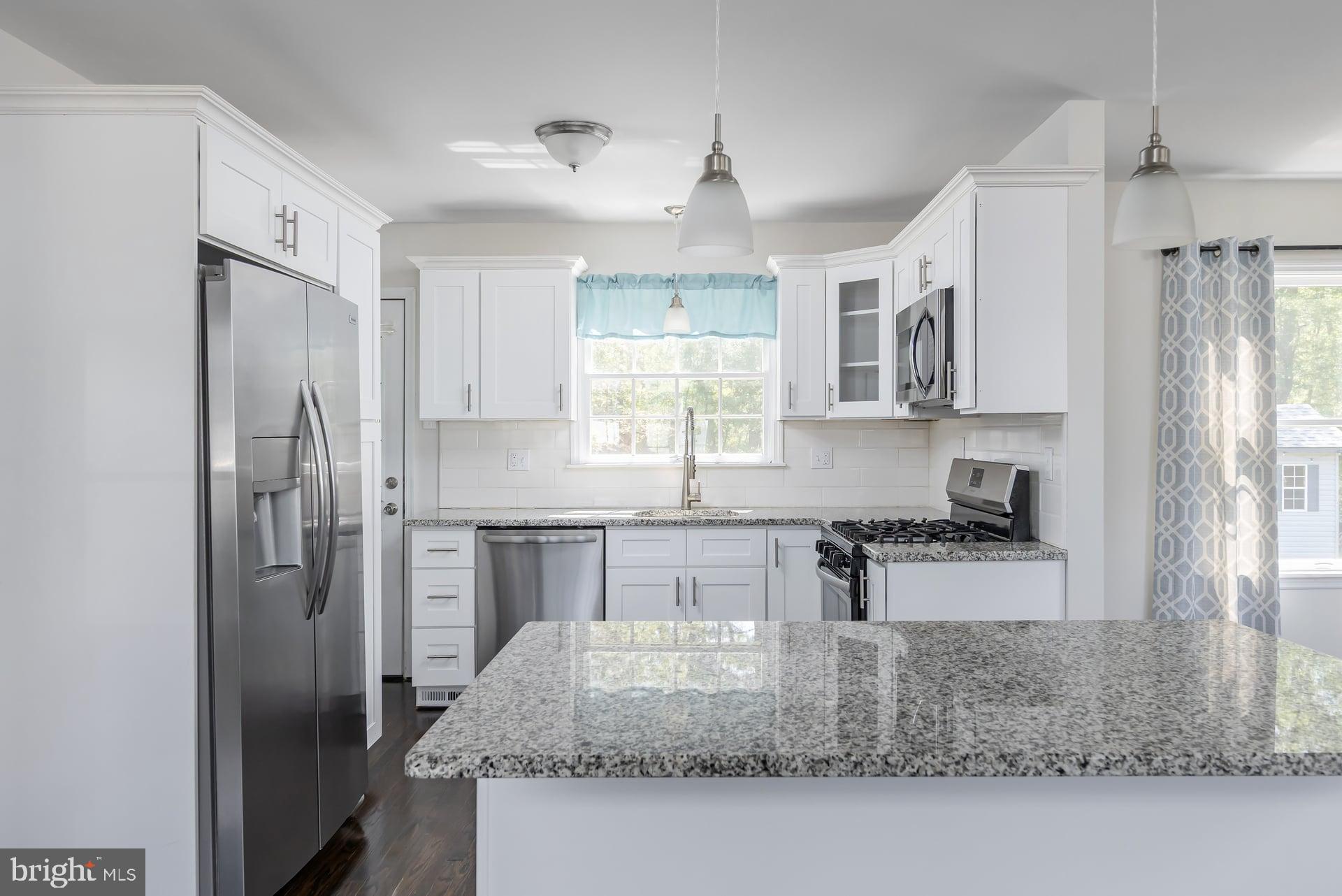 1203 Cedar Drive Pine Hill, NJ 08021 - Photo 7 of 19 a kitchen with stainless steel appliances granite countertop a refrigerator sink and stove