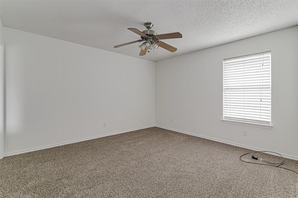 606 McAnear Street Cleburne, TX 76033 - Photo 11 of 19 an empty room with a window and a fan