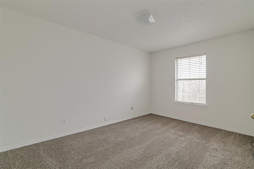 606 McAnear Street Cleburne, TX 76033 - Photo 13 of 19 an empty room with a window