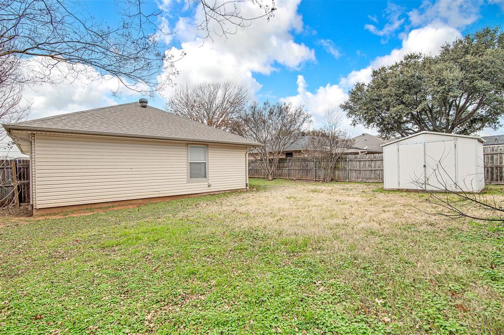 606 McAnear Street Cleburne, TX 76033 - Photo 19 of 19 a bathroom with a sink and a yard