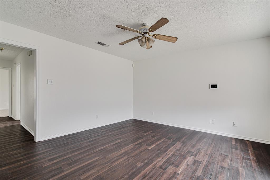 606 McAnear Street Cleburne, TX 76033 - Photo 2 of 19 a view of a room with wooden floor and ceiling fan