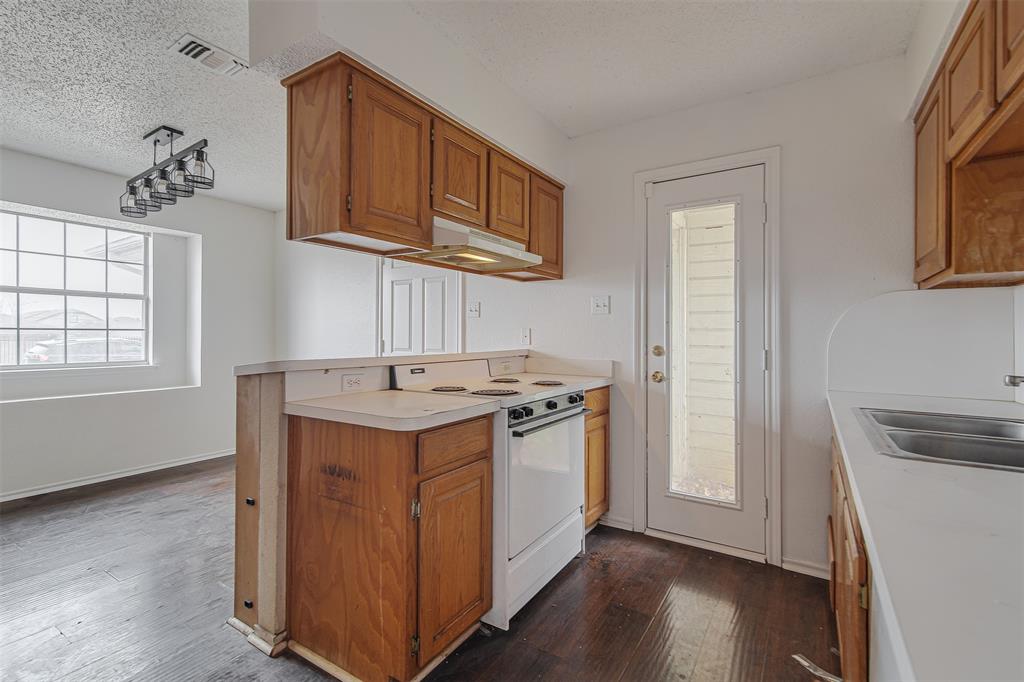 606 McAnear Street Cleburne, TX 76033 - Photo 7 of 19 a kitchen with a stove and a sink