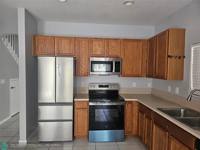 a kitchen with a refrigerator stove and microwave