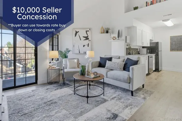a living room with furniture a rug and white walls