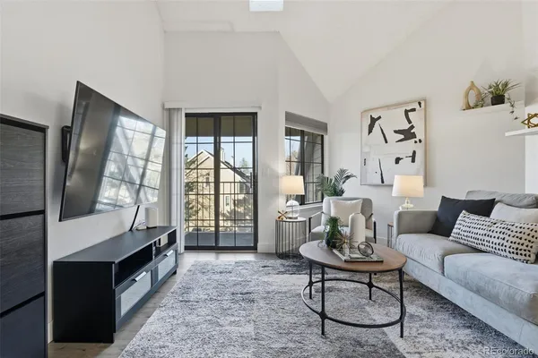a living room with furniture and large windows