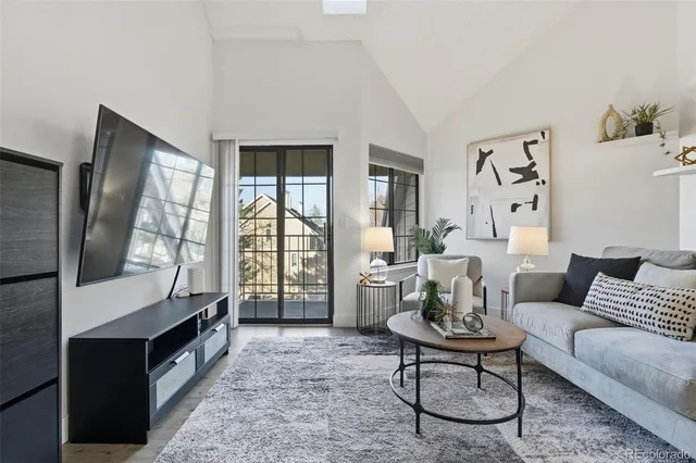 a living room with furniture and large windows