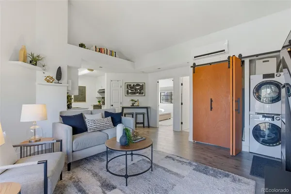 a living room with furniture a rug and a table