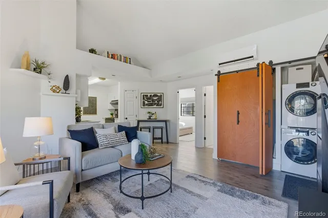 a living room with furniture a rug and a table