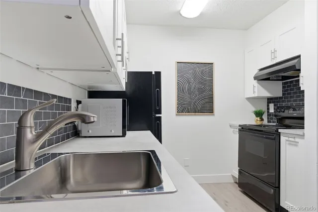a kitchen with a sink and a refrigerator