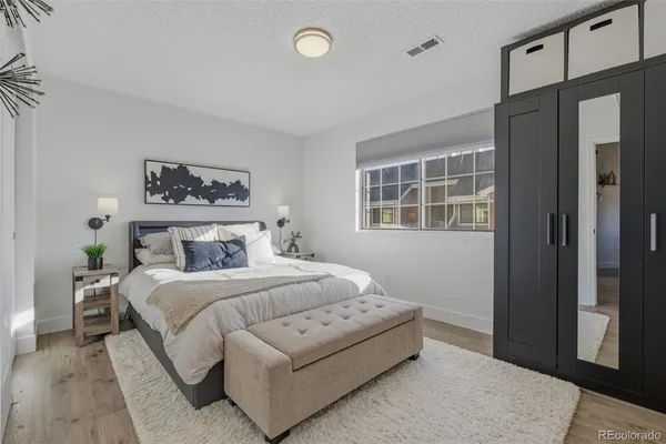 a bedroom with a large bed and a window