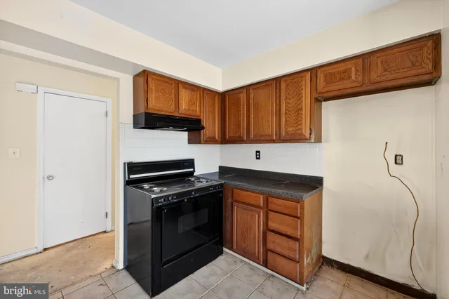 a kitchen with stainless steel appliances granite countertop a stove and a refrigerator