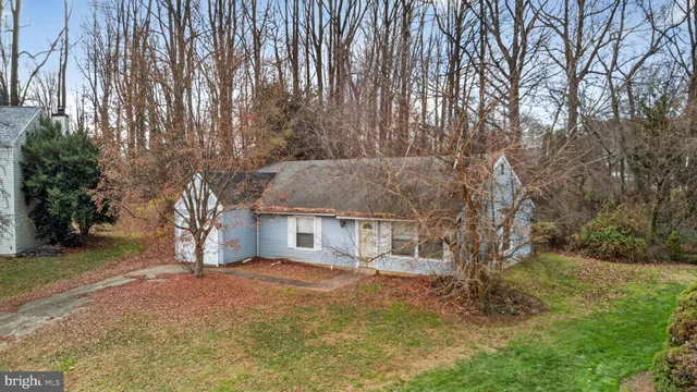 a view of house with outdoor space and sitting area