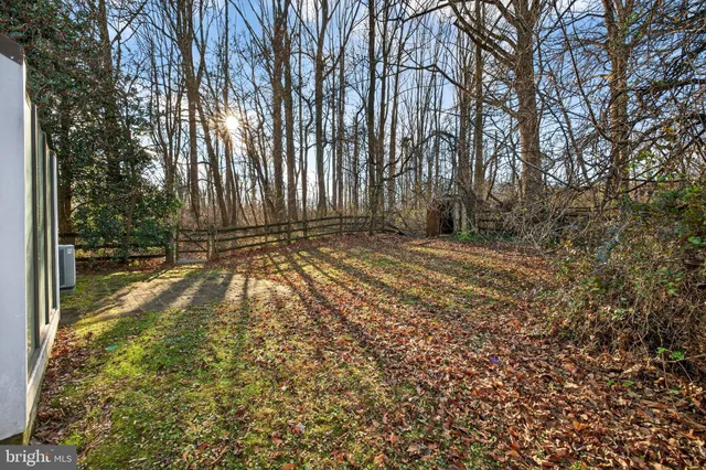 an aerial view of a houses with yard