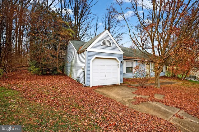 a front view of a house with a yard covered in snow