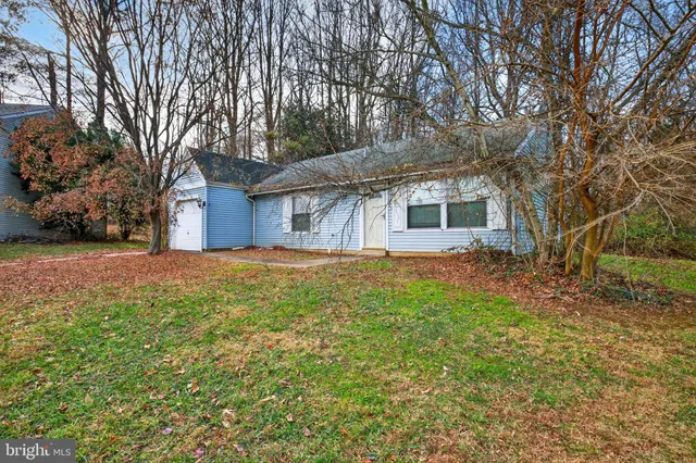 a front view of house with yard and trees