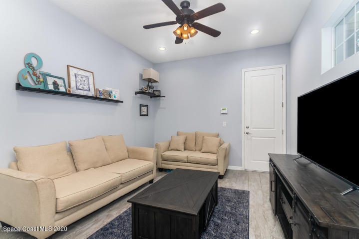 3465 Sedge Drive Rockledge, FL 32955 - Photo 3 of 12 a living room with furniture and a flat screen tv