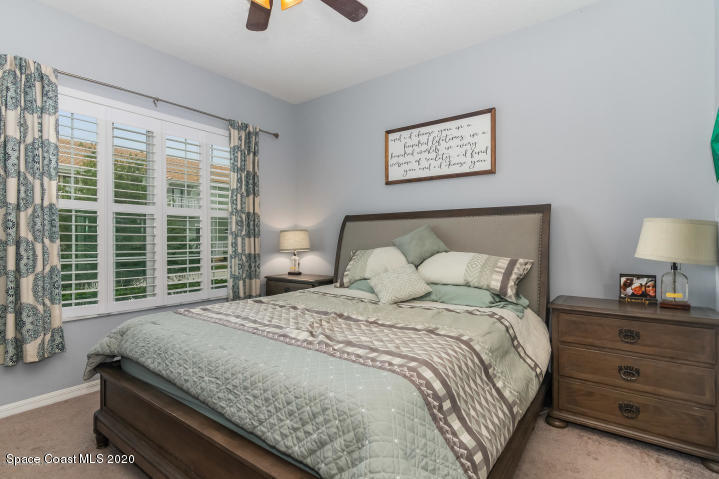 3465 Sedge Drive Rockledge, FL 32955 - Photo 5 of 12 a bedroom with a bed a window and a chandelier