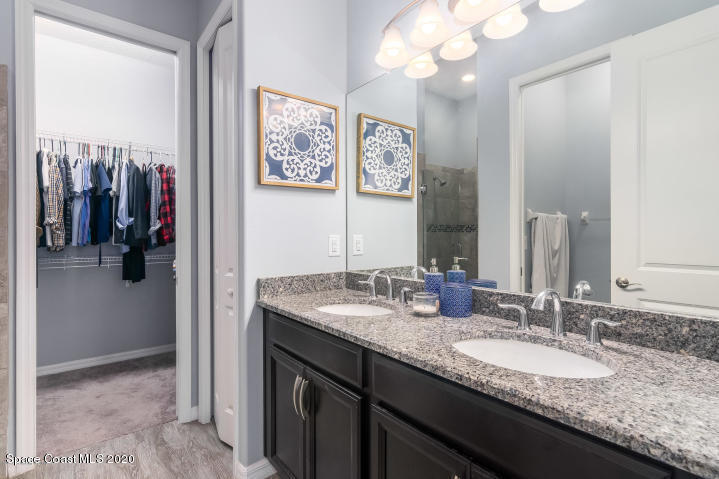 3465 Sedge Drive Rockledge, FL 32955 - Photo 6 of 12 a bathroom with a granite countertop sink and a mirror