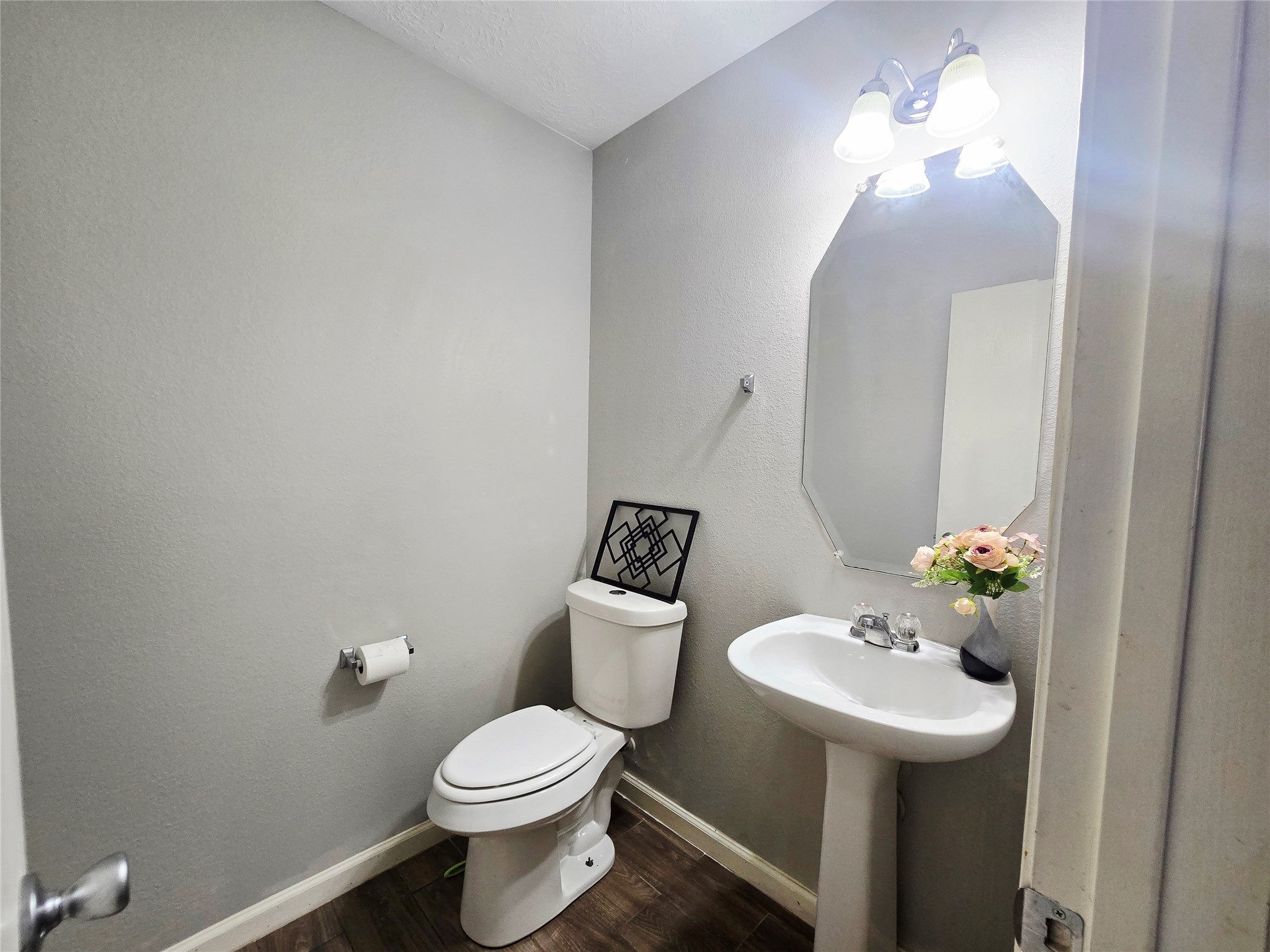 1011 Larks Trace Lane Houston, TX 77090 - Photo 14 of 26 a bathroom with a toilet sink and mirror