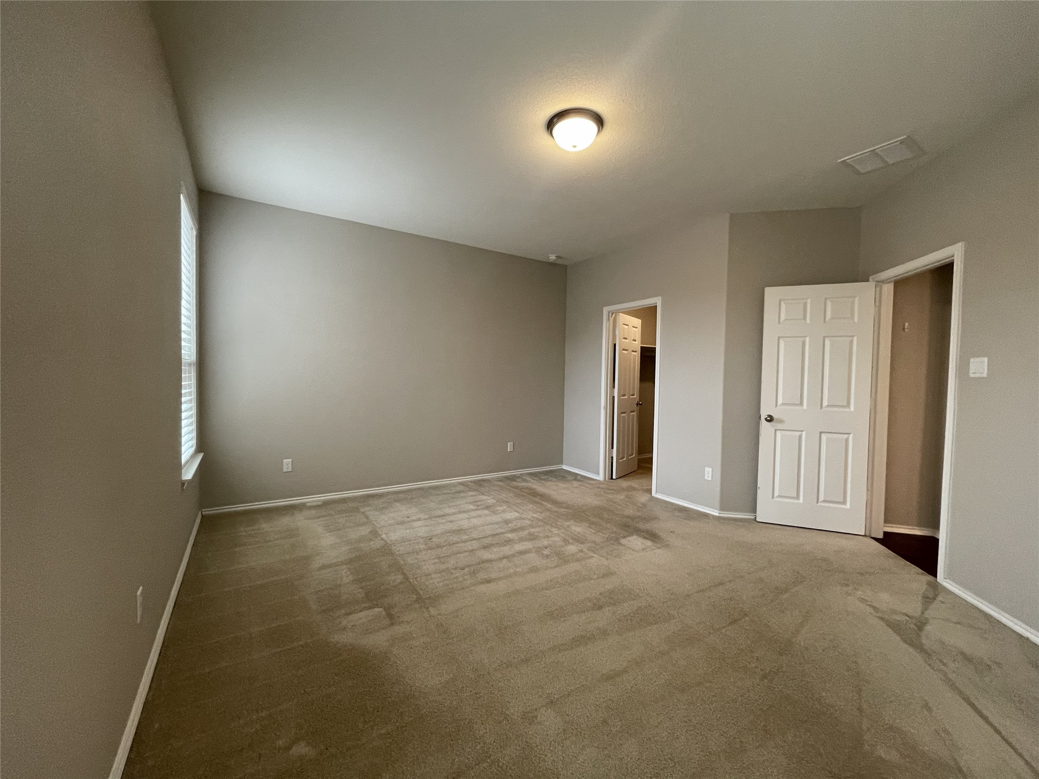 2471 Sunrise Road, Unit 62 Round Rock, TX 78664 - Photo 12 of 28 Unfurnished bedroom with carpet floors and a walk in closet