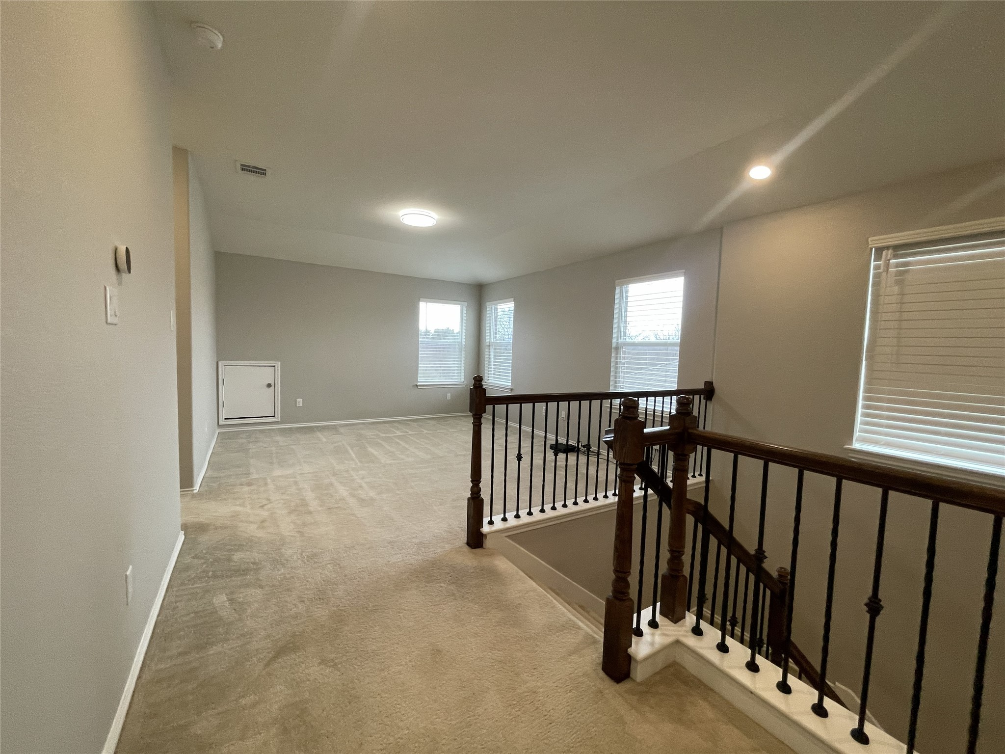 2471 Sunrise Road, Unit 62 Round Rock, TX 78664 - Photo 16 of 28 Corridor featuring an upstairs landing and light carpet