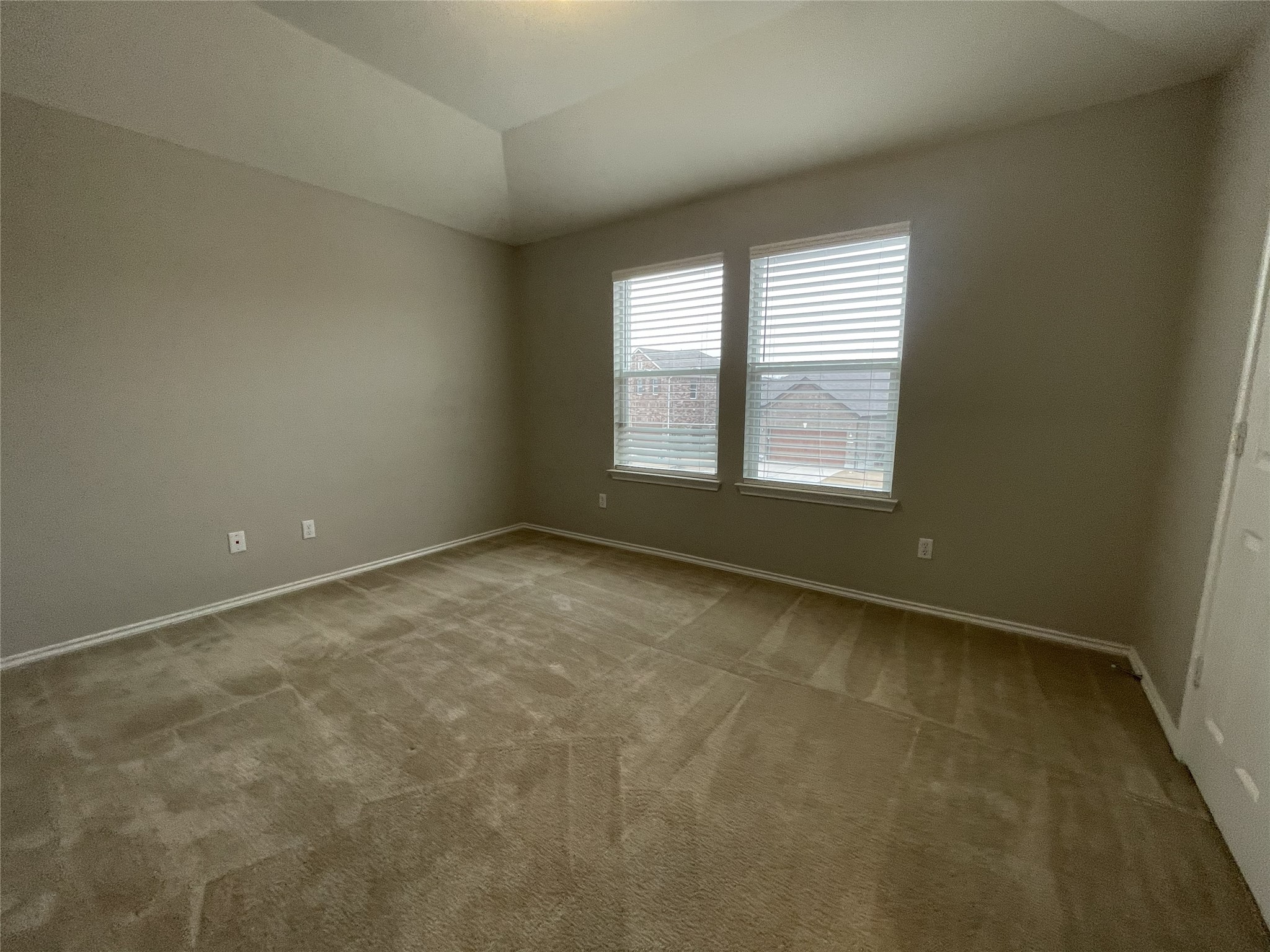 2471 Sunrise Road, Unit 62 Round Rock, TX 78664 - Photo 19 of 28 Spare room with light colored carpet and lofted ceiling