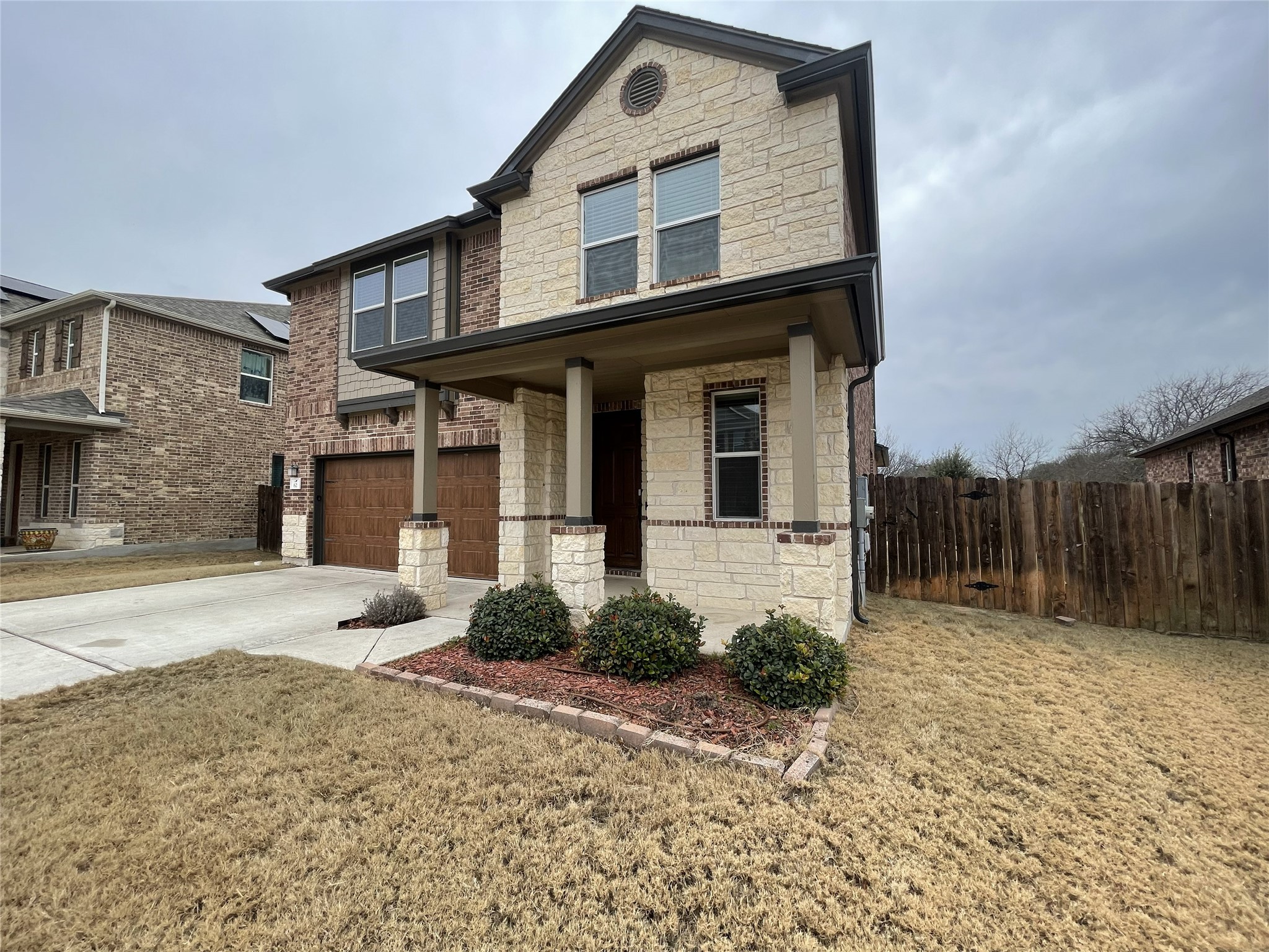 2471 Sunrise Road, Unit 62 Round Rock, TX 78664 - Photo 2 of 28 Craftsman inspired home featuring stone siding, an attached garage, covered porch, and concrete driveway