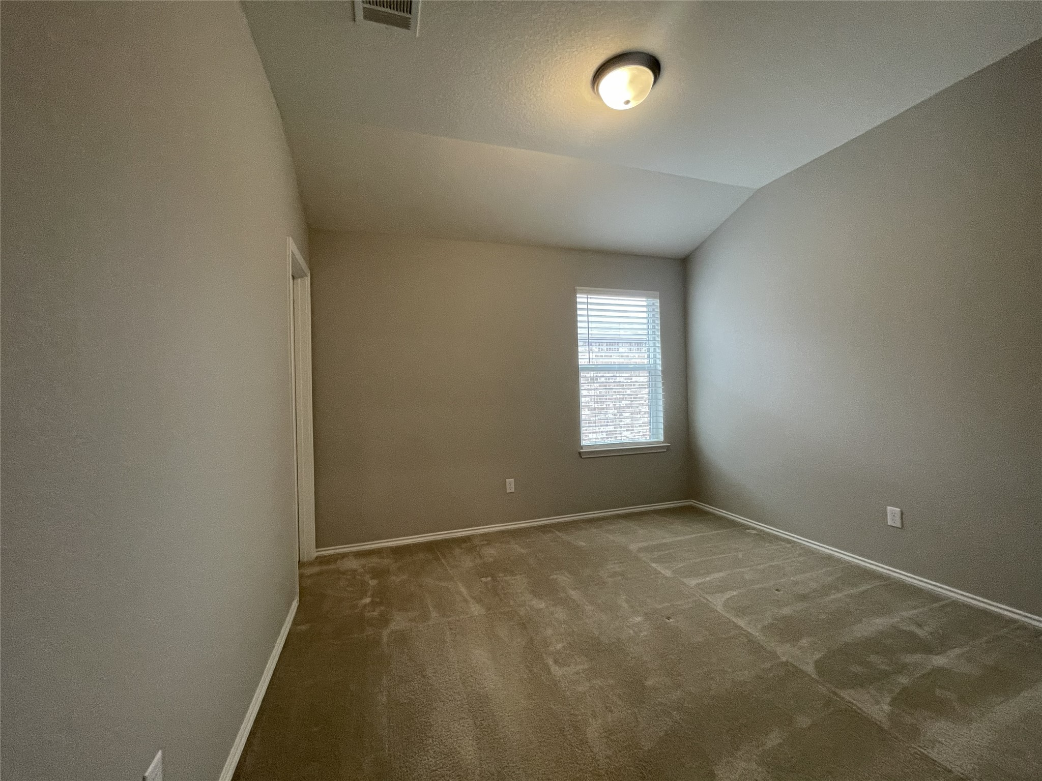 2471 Sunrise Road, Unit 62 Round Rock, TX 78664 - Photo 25 of 28 Carpeted empty room with vaulted ceiling and baseboards