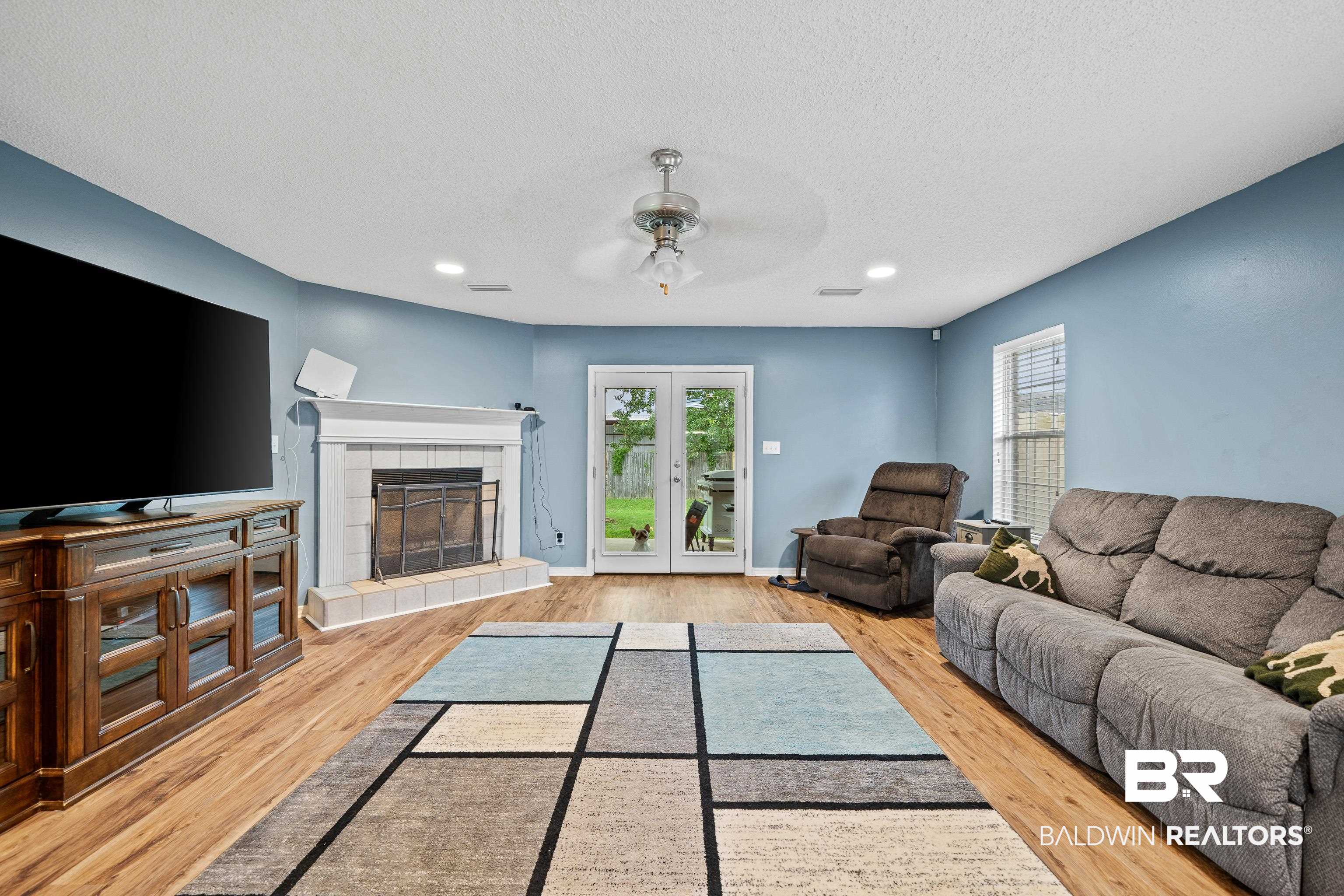 9552 Collier Loop Daphne, AL 36526 - Photo 13 of 28 Living area featuring ceiling fan, wood finished floors, a tile fireplace, a textured ceiling, and recessed lighting
