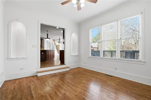 an empty room with a empty space and chandelier fan