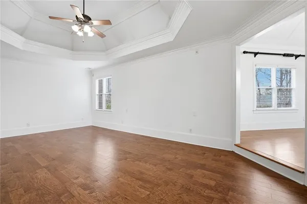a large bathroom with a large mirror vanity and bathtub