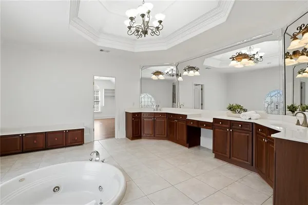 a view of a kitchen with white cabinets