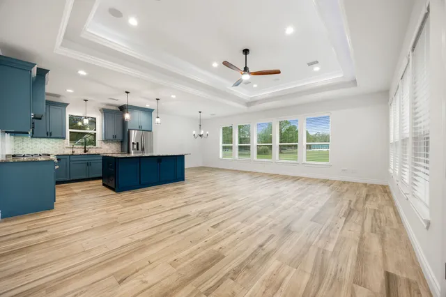 a view of kitchen with wooden floor and windows